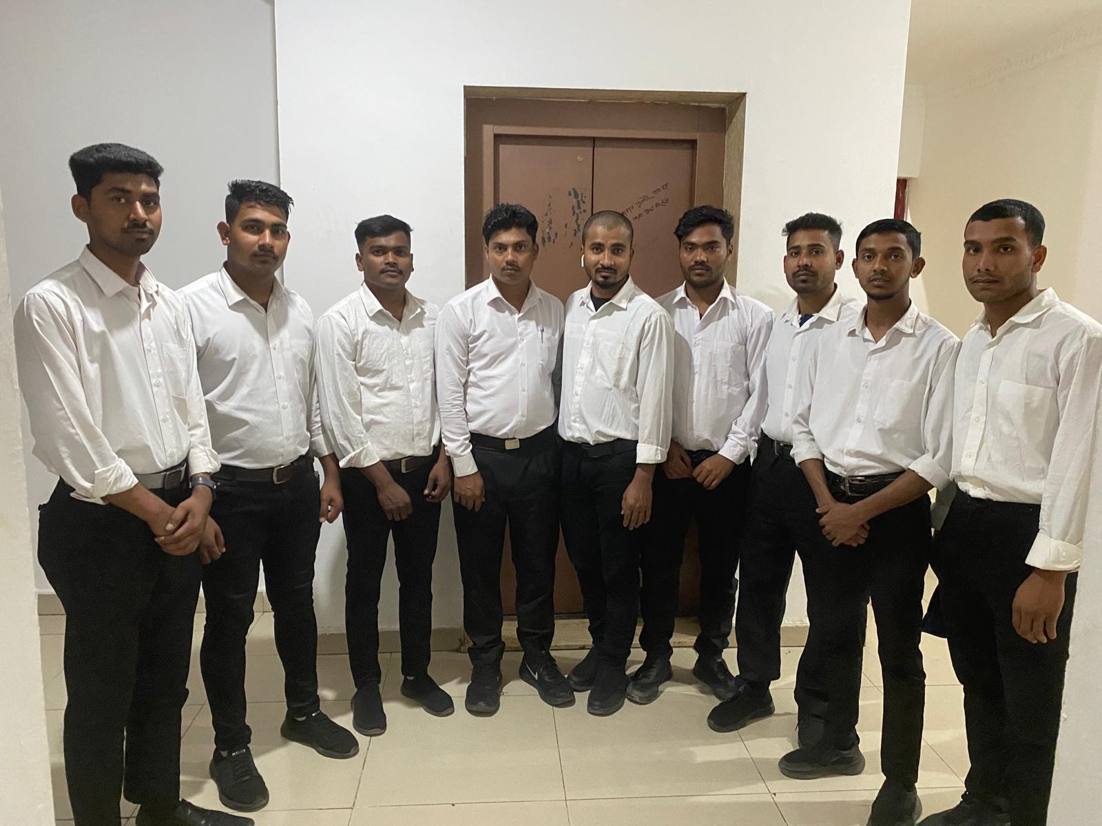 ABRAR Diamond team of nine staff members in formal attire